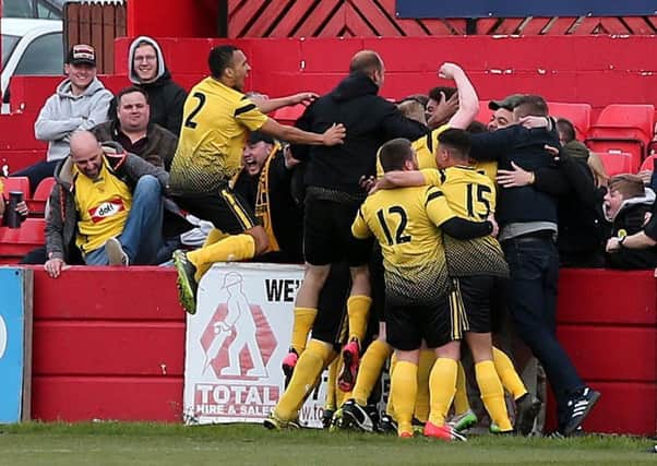 Hucknall Town players and supporters celebrate Adam Nelson's equalising goal, making the score 3-3.