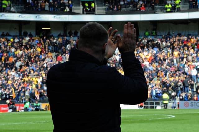 Mansfield Town v Milton Keynes.
David Flitcroft applauds the visiting fans at the start of the match.