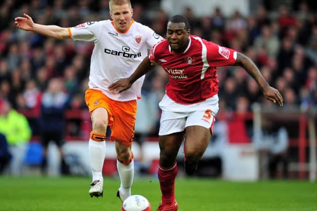 NOTTINGHAM, ENGLAND - MAY 11:  Wes Morgan of Nottingham Forest is challenged by Keith Southern of Blackpool during the Coca Cola Championship Play-Off Semi-Final Second Leg match between Nottingham Forest and Blackpool on May 11, 2010 in Nottingham, England.  (Photo by Clive Mason/Getty Images)