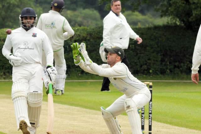 Hucknall wicket keeper Tom Walters receives the ball from the field ahead of the in-coming Bilal Shafayat.