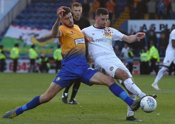 Mansfield's Ryan Sweeney battles with Newport's Padraig Amond in the play-off semi-final finale.