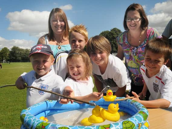 2010: This smiley bunch are having fun playing hook a duck at Hucknalls Rolls-Royce Leisure Junior Football Club fun day. Are you on this picture?