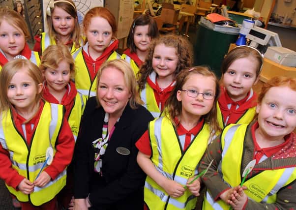 Janet Archer from Hucknall's Specsavers with members of the 1st Hucknall Rainbows who were presented with high visibility vests during their visit on Monday night.