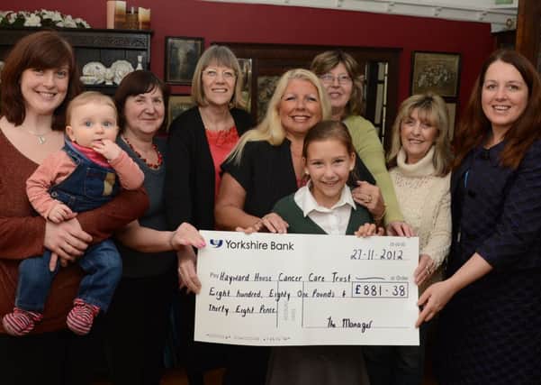 A group of ladies from Hucknall present a cheque for £881.38 to Haywood House G130320-2