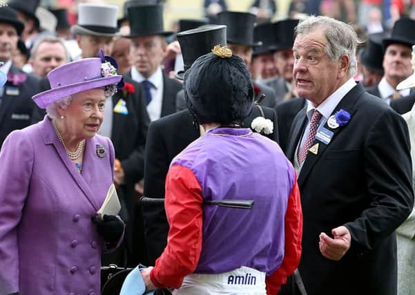 Queen Elizabeth II speaks with jockey Ryan Moore (centre) and Trainer Sir Michael Stout after victory in the Gold Cup on day three of the Royal Ascot meeting at Ascot Racecourse, Berkshire. PRESS ASSOCIATION Photo. Picture date: Thursday June 20, 2013. See PA story RACING Ascot. Photo credit should read: Steve Parsons/PA Wire