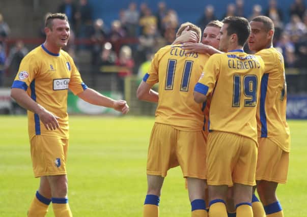 Players mob goalscorer Sam Clucas after he equalizes for Mansfield Town  -Pic by:Richard Parkes