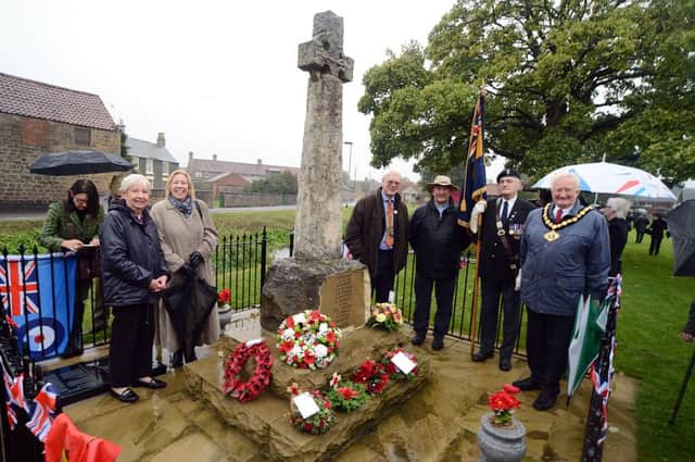 Local dignitaries, residents and family gather following the  re-dedication of the Langwith war memorial on Saturday morning, which has been refurbished.