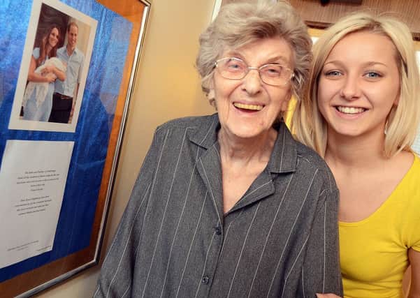 Resident Joan Thorpe, and care assistant Nikki Looms with the royal letter on display at Sutton Lodge Care Home.