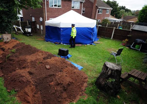 A general view of a police tent in the garden of a house in Blenheim Close, Forest Town, near Mansfield, where the remains of two people have been found.  PRESS ASSOCIATION Photo. Picture date: Friday October 11, 2013. See PA story POLICE Remains. Photo credit should read: Rui Vieira/PA Wire