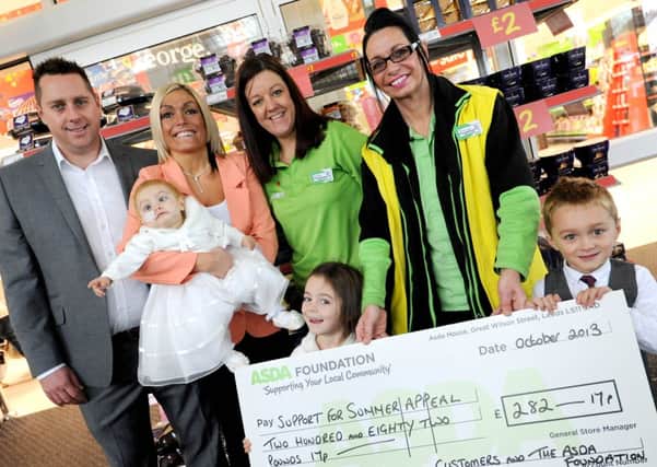 ASDA Sutton branch has been raising money for ex employee's daughter who is terminally ill at the age of 1. l-r back Mark Smith, Marion Betts holding Summer Louise Smith, Hayley Carrington, Bronwyn Bearder, front is Erin Bowe 6 and Bailey Smith 4.