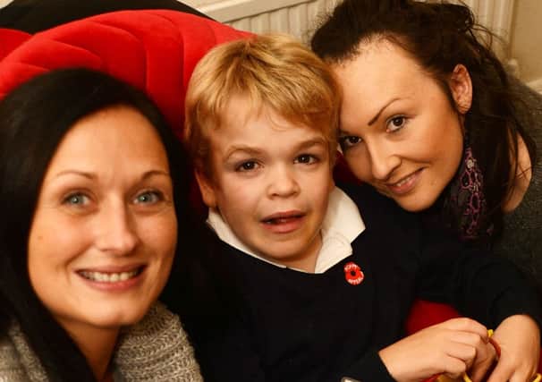 Jacob Brentnall with his mum Hannah, right and Donna Corcoran who has written a poem about him.