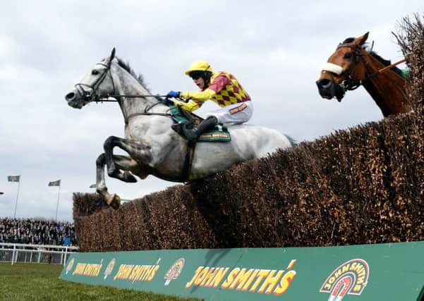 Dynaste and Tom Scudamore (left) jump the final fence on their way to victory in the John Smiths Mildmay Novices Chase during Ladies Day at the 2013 John Smith's Grand National Meeting at Aintree Racecourse, Sefton. PRESS ASSOCIATION Photo. Picture date: Friday April 5, 2013. See PA story RACING Aintree. Photo credit should read: John Giles/PA Wire