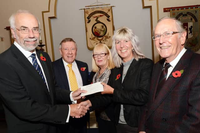 Mr David Stoakes, left, the Worshipful Master of the Broxtowe Lodge, hands over a £4,250 to Carol Burkitt, the chief executive of APTCOO, also pictured are continuing left, Brian Payne chairman of the Broxtowe Lodge centenary committee, Trish Green founder member and trustee of APTCOO and Kevin Shaw.