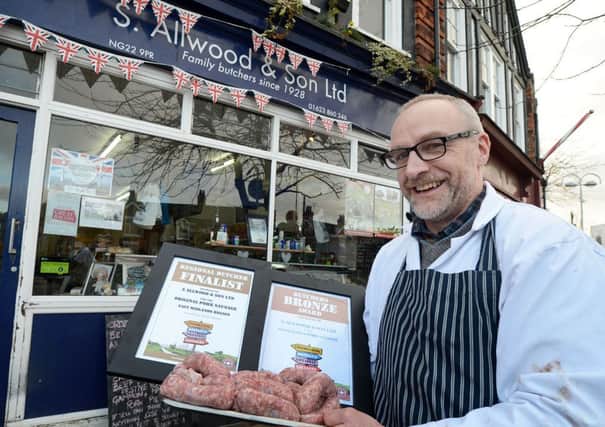Butcher, Richard Allwood, shows off his award winning sausages.