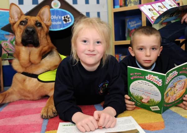 Pets as Therapy visits Abbey Hill Primary School with their dog 'Olly Murs' to help the children gain confidence with their reading. Kadie Walker 6 and Kyle Brown 7.