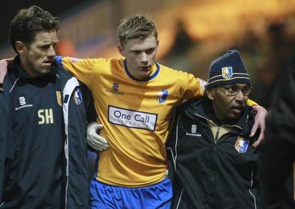Sam Clucas is assisting down the tunnel by the medical staff -Pic by:Richard Parkes