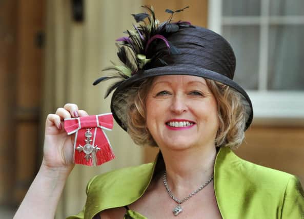 Jean Hardy proudly holds her MBE, after it was presented to her by the Prince Of Wales, during the Investiture Ceremony at Buckingham Palace in central London. PRESS ASSOCIATION Photo. Picture date: Friday November 18, 2011. See PA story ROYAL Investiture. Photo credit should read: John Stillwell/PA Wire