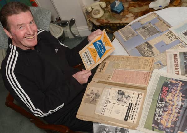 Ivan Hollett looking back at his scrap books from his Mansfield days.