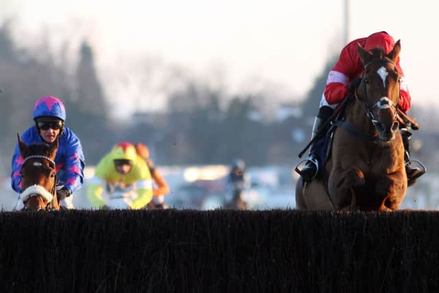 KING FOR A DAY -- Silviniaco Conti jumps the last, ahead of Cue Card and Al Ferof, on his way to victory in the King George at Kempton on Boxing Day. (PHOTO BY: Steve Parsons?PA Wire)