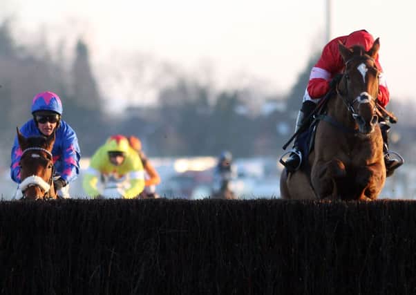 KING FOR A DAY -- Silviniaco Conti jumps the last, ahead of Cue Card and Al Ferof, on his way to victory in the King George at Kempton on Boxing Day. (PHOTO BY: Steve Parsons?PA Wire)