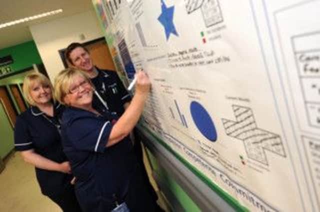 Pictured (with pen) is unit leader Diane Reason, with Sister Mel Bull and Practice Development Matron Adam Hayward.