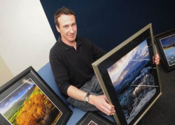 Martin Leighton setting up his exhibition of landscape photography at Hucknall Library.