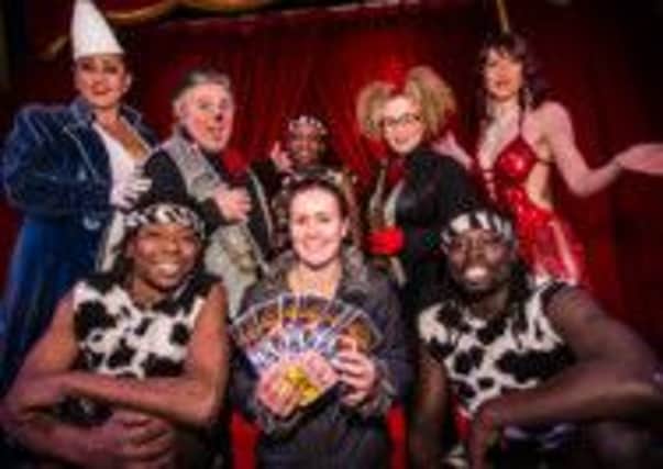Foodbank Fantasia Circus Tickets

Rebecca Savage (centre with tickets) surrounded by performers from Fantasia Circus
