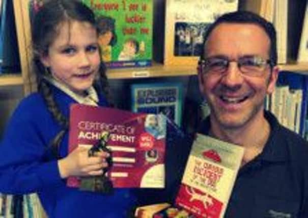 At a stroke: Lucia Light, who has raised money for the book fund at Dalestorth School, with literacy co-ordinator Robert Rumsby.