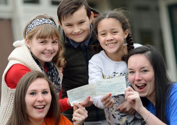 Broomhill Junior School pupils hand over cheques to London Marathon runners Chantal Duarte, left and Lauren Mellor, to go towards their fundraising efforts for Childhood First and the British Lung Foundation.  Pictured are Sophie Tyas, Kyle Kendrick and Liberty Wallace.