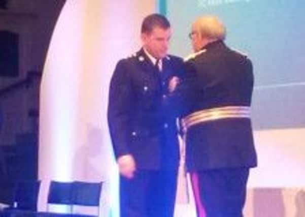 Chief inspector Paul Winter picks up an award for his long service.