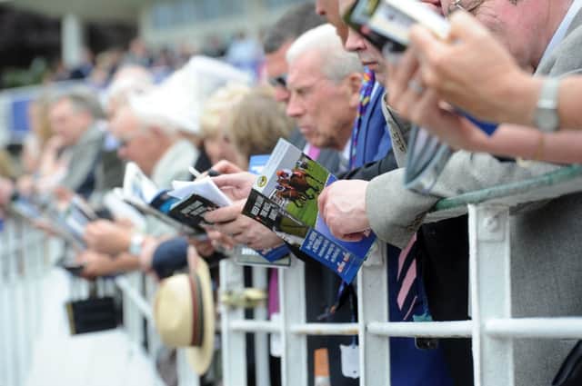 Date:15th May 2014, picture James Hardisty, (JH100369l). Ladies Day at York Race Course Dante Festival, pictured Race goers watching the main race of the day The Betfred Dante Stakes.