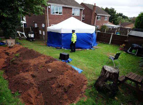 A general view of a police tent in the garden of a house in Blenheim Close, Forest Town, near Mansfield, where the remains of two people have been found.  PRESS ASSOCIATION Photo. Picture date: Friday October 11, 2013. See PA story POLICE Remains. Photo credit should read: Rui Vieira/PA Wire