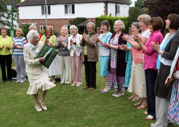 Marjorie Eyre show off the baton to other members of Ravenshead WI.