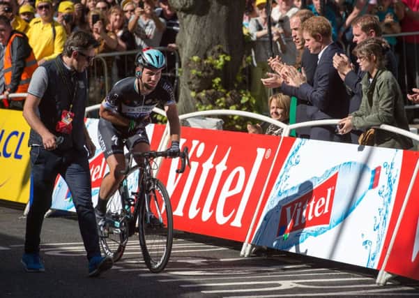 Crash injured Mark Cavendish applauded by The Duke of Cambridge and Prince Harry as he rides over the finish line in Harrogate. Photo: Tim Ireland/PA Wire