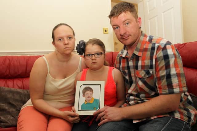 Laura, Stephen, and Chloee Gregory from Kirkby with a photo of Corey who died aged 11 after suffering from a rare condition which affected his immune system.