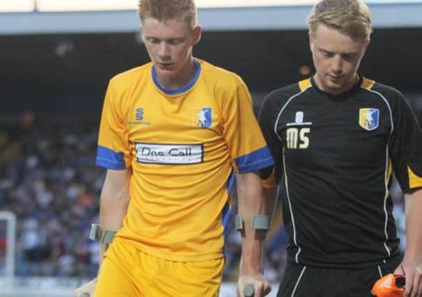 Sam Clucas leaves the field of play with an ankle injury -Pic by: Richard Parkes