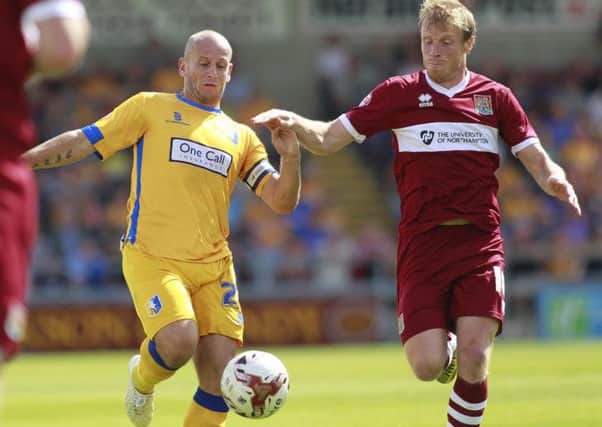 Adam Murray in a midfield duel -Pic by: Richard Parkes