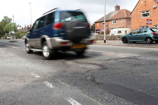 Potholes on Mansfield Road with the junction of Guylers Hill Road in Clipstone.