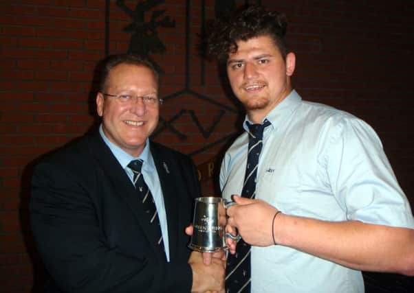 Joe Symcox receives the man of the match award on Saturday from club chairman Andy Foster.