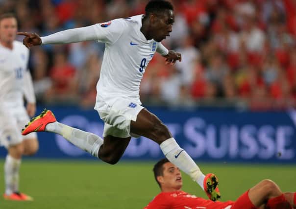 England's Danny Welbeck scores his team's opening goal against Switzerland.