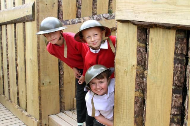 Farmilo pupils Rhys Jones, Kieran Hall and Sam Mycroft peer around a corner in the trench.