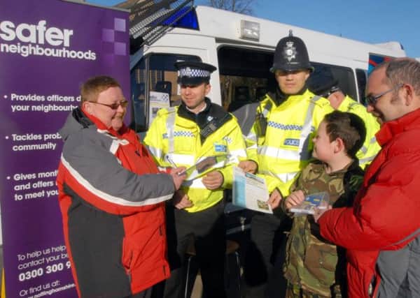 Community Police Day in Hucknall. 
PCSO Simon Gazzard and PC Simon Lacey hand over a Smartwater set to the Werle family.