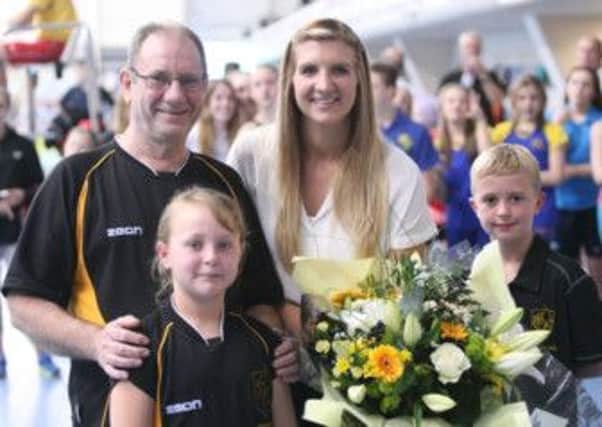 Becky Adlington with Sherwood coach Ian Negus and young swimmers Suranne Cave and Joseph Lewis, who presented her with a bouquet of flowers.