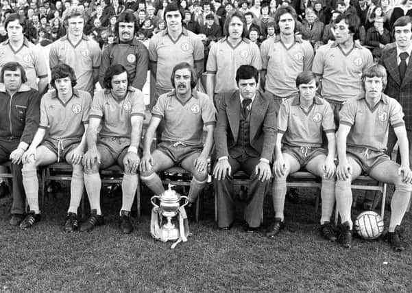 Mansfield Town Div Three Championship pres 1977Left to right. Back row; I. McDonald, I. Wood, R. Arnold, E. Moss, K. Bird, I. McKenzie, C. Foster and B. Foster.Front row; G. Clarke, R. Cooke, K. Randall, G. Hodgsom, P. Morris. P. Matthews and B. McEwan.