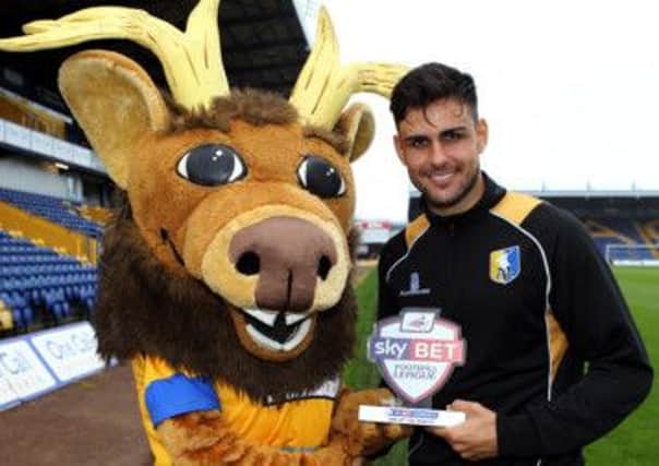 Sammy the Stags receives the award on behalf of Craig Ploughman from Stags defender Ryan Tafazolli.