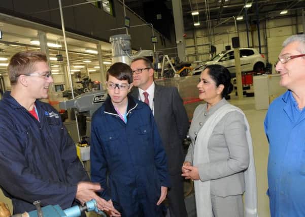 Dame Asha Khemka chats with students, Arturs Kurklis and Corey Tindall during a visit to the new Vision West Notts College's Engineering Innovation Centre on Monday.