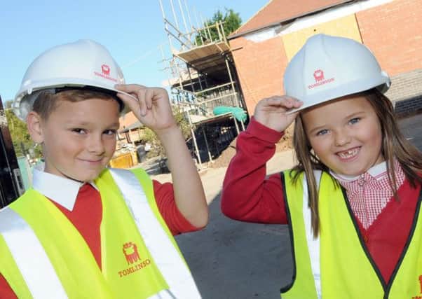Pupils at the Forest Town Primary and Nursery School, Jack Tyler and Macie Kimberley tip their hats to the building of a  new foundation unit at their School.