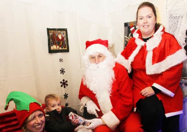 Keycraft Garden Buildings in Hucknall are having a Santa's Grotto in December with proceeds going to Hayward House Hospice and Wish Upon A Star. Blase Hallam, two, is pictured with Santa. nhud-24-11-14 santa huc(2)