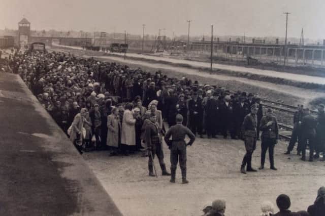 Newly-arrived prisoners at Birkenau death camp awaiting selection. Around 90 per cent of those who arrived were sent straight to the gas chambers. Picture credit: http//:grahamsimages.com