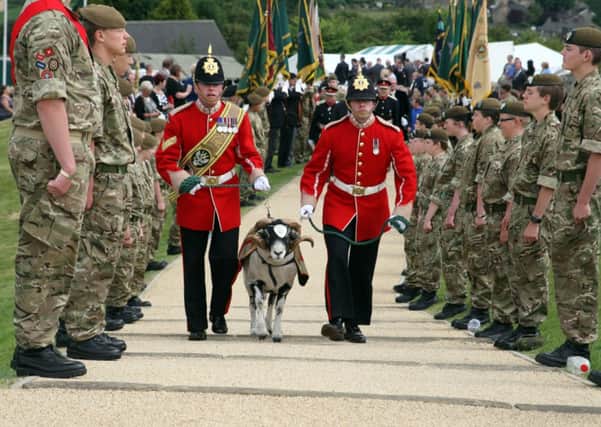 MASCOT -- Corporal Philip Thornton and Private Josh Roberts lead the Mercian Regiment's mascot, Swaledale ram Private Derby, on to parade.